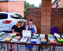 Friends Board Members selling art for scholarships